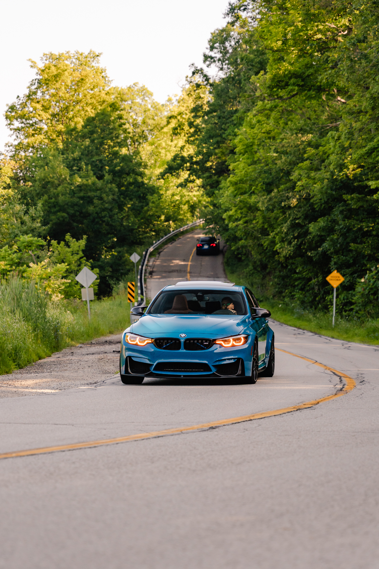 Front view showing the amber DRL daytime running lights on the Laguna Seca Blue M3